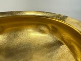 a close up of a gold plate on a table