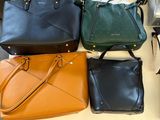 a lot of purses that are on a table