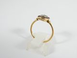 a close up of a gold ring with a stone in the middle
