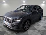 the new audi qx suv is parked in a showroom