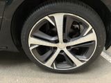 a close up of a car ' s wheel on a parking lot
