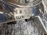 a close up view of a metal grinder on a carpet