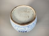a close up of a blue and white cup on a table