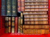 many old books in a red basket on the table