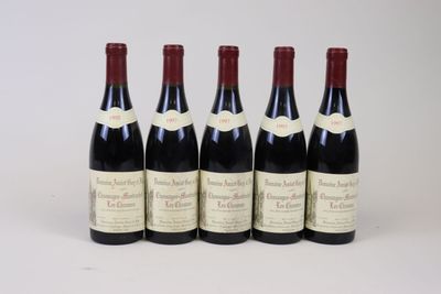 six bottles of wine are lined up on a white surface