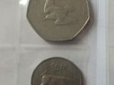 three different coins are in a clear plastic bag on a table