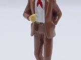 a figurine of a man in a suit and tie