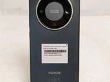 the back of a black cell phone with a barcode on it