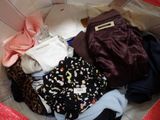 a basket full of clothes that is sitting on the floor