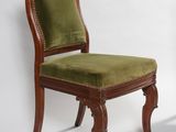 an image of a green chair against a white wall