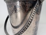 a silver bucket that is sitting on a table