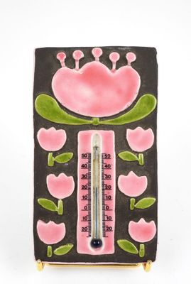 a thermometer with a pink flower design on it