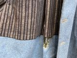 a close up of a person wearing a suit and tie