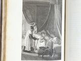un livre ouvert sur lequel figure l'image d'une femme et d'un enfant dans un lit
