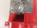 a red machine that is sitting on a white surface