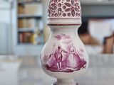 a white and purple vase sitting on a table