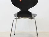 a black chair with a red dot on the seat