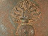 a close up of a large metal pot with a tree on it