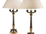 pair of brass and black table lamps with white lampshads