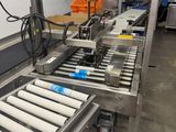 a conveyor belt in a factory with a lot of machines