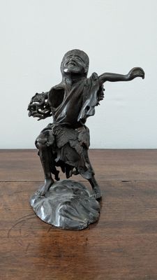 a statue of a man with a dog on a table