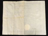 a close up of a piece of paper on a black surface