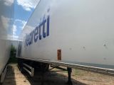 two semi trucks parked next to each other on the side of the road