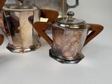 a silver tea pot and a silver teapot on a table
