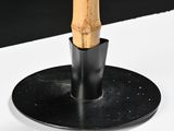 a wooden stick sticking out of a black plate on a table