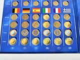 a lot of different coins on the blue board