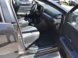 a car that has its door open and is parked in a lot