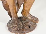 a statue of a man holding a bird on his arm
