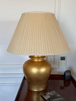 a lamp that is sitting on a table next to a remote control
