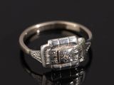 an image of a diamond ring on a black surface