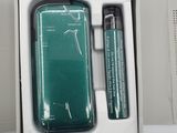 a box with a cell phone and a pen in it