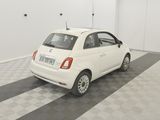 a picture of a small white car parked in a garage
