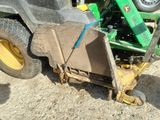 a tractor that is sitting in the dirt with a box on it