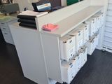 a white counter with a bunch of boxes on top of it