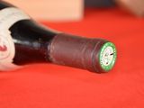 a bottle of wine sitting on a red table cloth