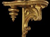 an image of a pair of gold brackets on a black background