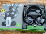 an image of a box of headphones sitting on a wooden table