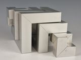 three boxes stacked on top of each other on a table