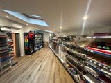 many shelves in the store with many items on them