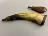 two pieces of horn are sitting on a table next to each other