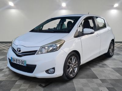 la toyota yaris blanche est garée sur un sol en damier