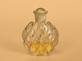 a small glass bottle with a gold decoration on it