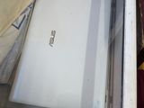 a white laptop sitting inside of a glass case