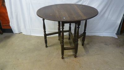 a small table with a wooden top on the floor