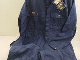a blue work suit sitting on top of a table next to a hanger