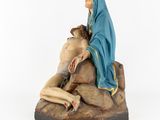 statue of jesus on the cross with a woman on a rock